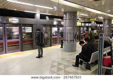 Tokyo, Japan - December 1, 2016: People Wait For Subway Train In Tokyo. Toei Subway And Tokyo Metro 