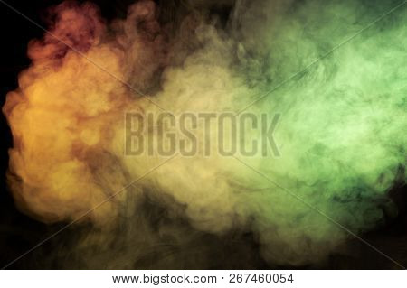Multicolored Smoke Of Red Yellow And Green Colors From A Vap Scattering On A Black Isolated Backgrou
