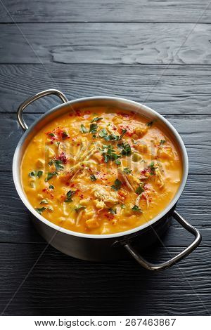 Overhead View Of Delicious Butternut Squash Chicken Breast Creamy Soup In A Metal Casserole On Black