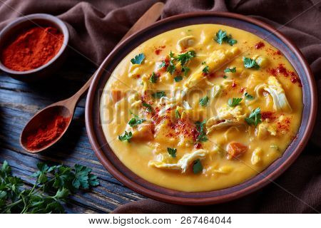 Hearty Pumpkin Carrot Chicken Breast Creamy Soup In An Earthenware Bowl On A Rustic Table With Brown