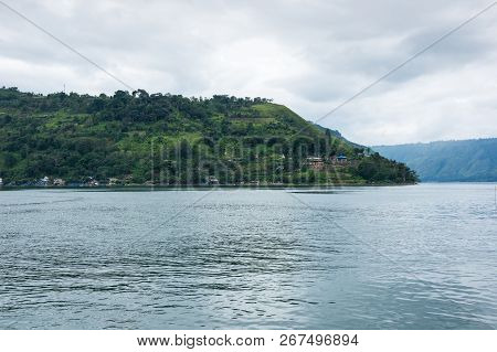 Lake Toba Is A Large Natural Lake Occupying The Caldera Of A Supervolcano, Located In The Middle Of 