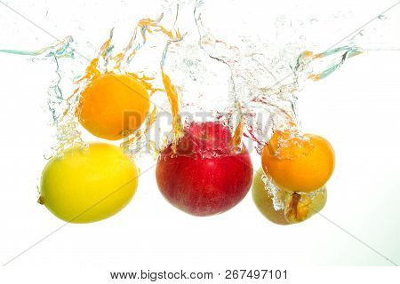 Varius Colorful Fruits Apple Pear Lemon And Clementine Splash In Water In White Background