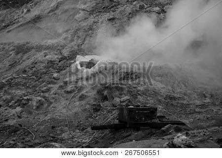 Sulfuric Smoke Rising From A Hole In The Groud Black And White