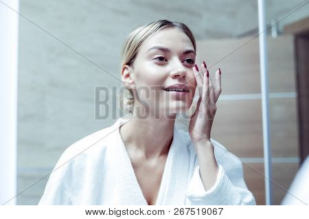 Slim Appealing Woman Feeling Good Taking Care Of Her Face Skin