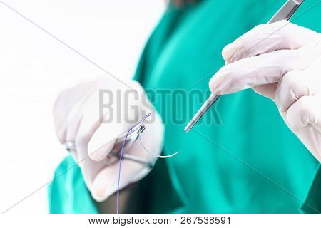 Doctor Holding Surgical Forceps Suture Needle, Suturing Material