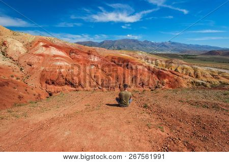 Relaxing man in Valley of Mars landscapes in the Altai Mountains, Kyzyl Chin, Siberia, Russia
