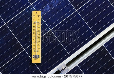 Thermometer On Solar Panel. The Photo Present The Concept Of Heat Effect On The Solar Panel That Wil