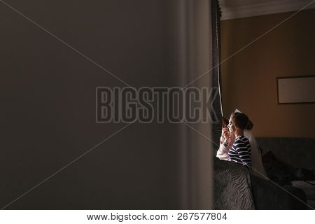 Makeup Artist Doing Brows And Applying Eyeshadow On Bride Face Close-up. Stylish Bride Getting Her M