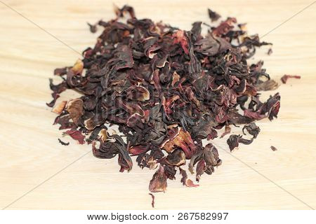 Dry Carcade Sudanese Rose On Wooden Desk