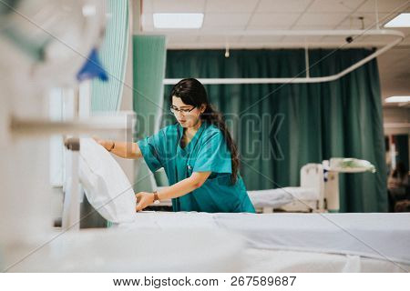 Nurse making the bed at a hospital