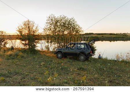 Dnipropetrovsk Region, Ukraine - June 19, 2017: Vaz Niva Blue-green Color Near The River On Sunset, 
