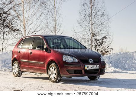 Dnipropetrovsk Region, Ukraine - February 03, 2014: Volkswagen Polo Burgundy Color On The Winter Roa
