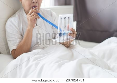 Patient Elderly Woman Using Incentivespirometer Or Three Balls For Stimulate Lung In Room