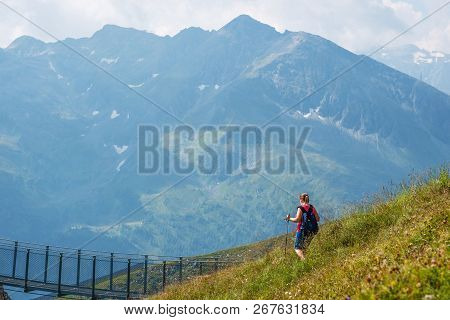Bad Gastein, Austria - August 06, 2018: Female Hiker Hiking Down Alpine Hills With Nails.