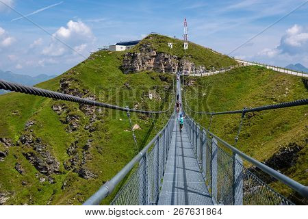 Bad Gastein, Austria - August 06, 2018: People Cross A Suspension Bridge On The Stubnerkogel, Gastei