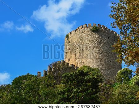 Tower Of The Fortress Rumeli Hisari Against The Blue Sky And Greenery.