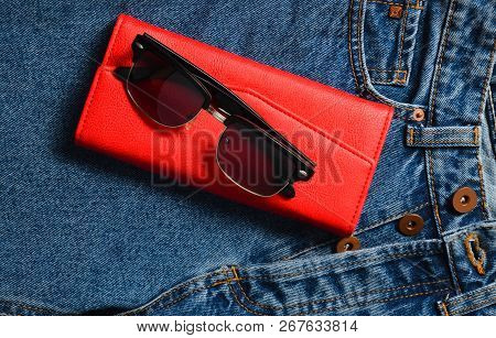 Women's Things And Accessories. Classic Sunglasses, Red Leather Purse, Jeans.