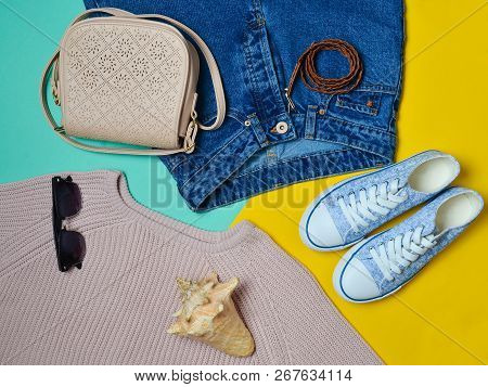 Women's Clothing, Shoes And Accessories On A Blue Yellow Pastel Background. Fashionable Look. Sneake