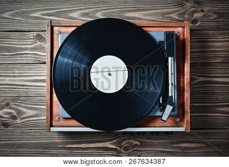 Vinyl Player With Plates On A Wooden Table. Entertainment 70S. Listen To Music. Top View.