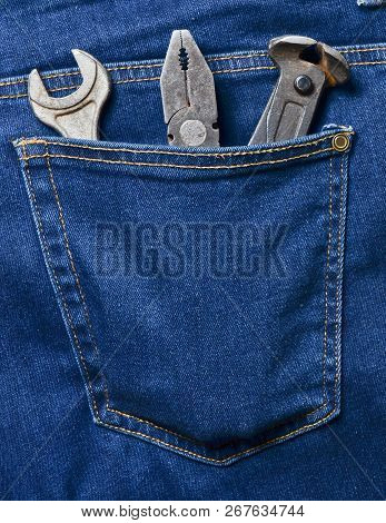 Pliers, Nippers, Wrench In The Pocket Of Classic Blue Jeans. Work Tool.