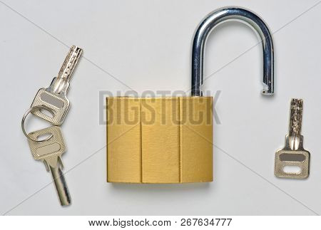 An Open Gilded Castle And Keys Isolated On A Gray Background. Home Protection From Theft.