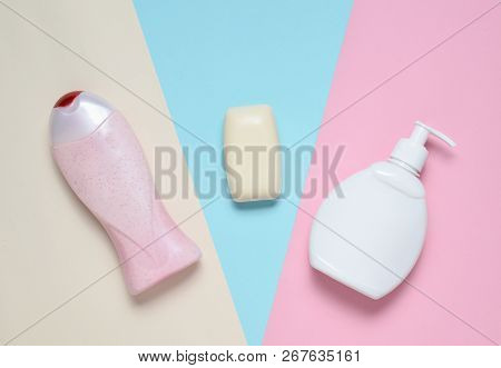 Body And Hair Care  Products On A Multi-colored Pastel Background. Lotion, Soap, Shampoo. Top View.