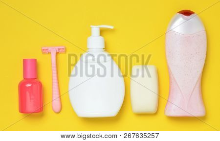 Products For The Care Of Body, Hair And Personal Hygiene On A Multi-colored Paper Background. A Bott