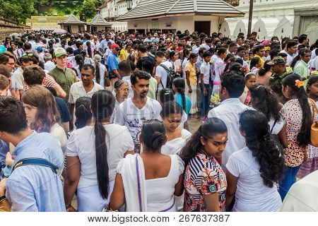 Kandy, Sri Lanka - July 19, 2016: White Clothed Buddhist Devotees Wait In A Queue At The Entrance To