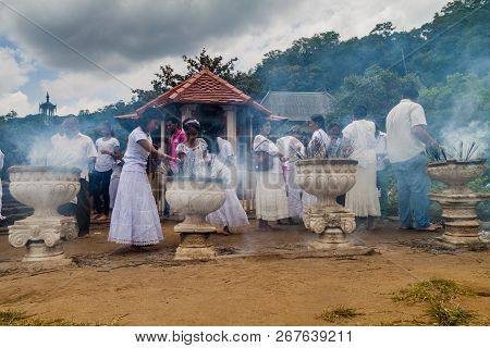 Kandy, Sri Lanka - July 19, 2016: White Clothed Buddhist Devotees Light Incense Sticks At The Temple