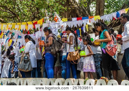 Kandy, Sri Lanka - July 19, 2016: White Clothed Buddhist Pilgrims Visit Wel Bodiya With Bodhi Tree D