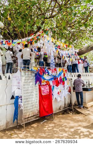 Kandy, Sri Lanka - July 19, 2016: White Clothed Buddhist Pilgrims Visit Wel Bodiya With Bodhi Tree D