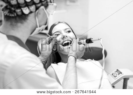Dentist Examine Female Patient With Braces In Denal Office.