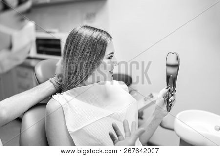 Dentist Showing Result Of Treatment For The Patient.