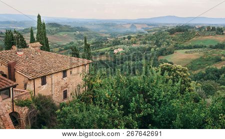 Rural Landscape With Gardens And Roofs Of Mansions At Evening Tuscany. Green Trees, Hills Of Country