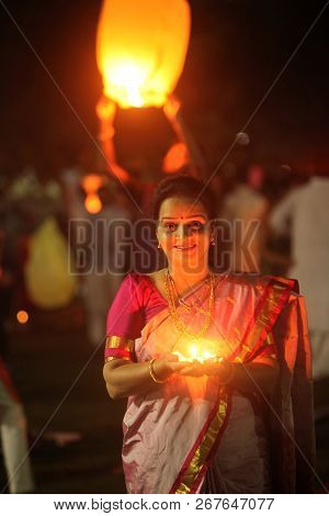 Pune, India - November 2018: A Woman Lights Up A Lamp During A Public Celebration Of Diwali Festival