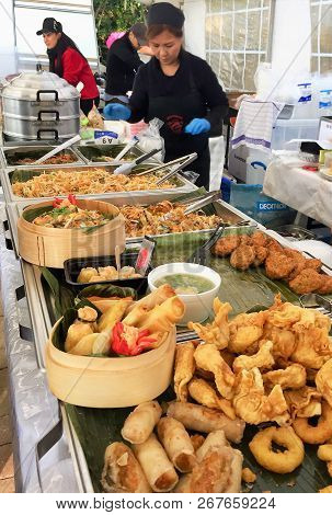 Waterloo, Belgium - November 4, 2018: Thai Street Food. Women Prepare And Serve Authentic Thai Food 