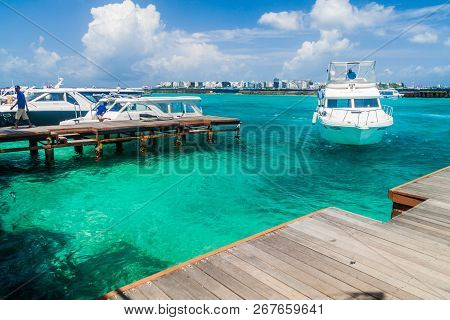 Hulhule Island, Maldives - July 11, 2016: Boats At The Harbor Next To Ibrahim Nasir International Ai