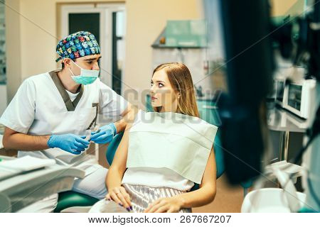 Dentist Examine Female Patient With Braces In Denal Office.