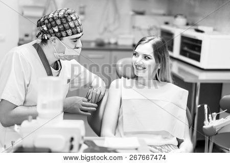 Dentist Examine Female Patient With Braces In Denal Office.
