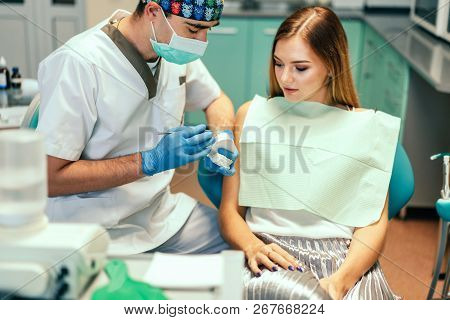 Dentist Examine Female Patient With Braces In Denal Office.