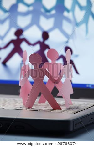 Paper chain dancing on a laptop.