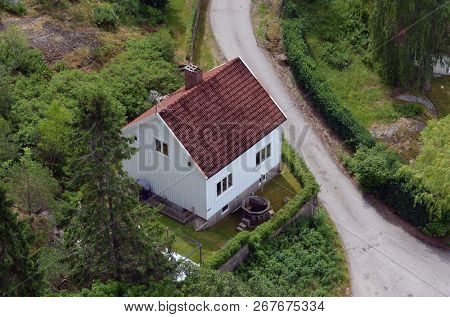 Typical Swedish nature and houses on the shore of the fjord. View from the high bridge over the fjord. The border of Norway and Sweden.June 18,2018.Near the town Selater,Sweden