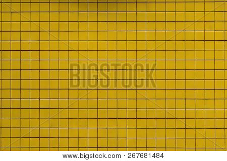 Close-up Of A Yellow Colored Tiled Wall Background Or Texture. 
Geometric Shapes And Backgrounds.