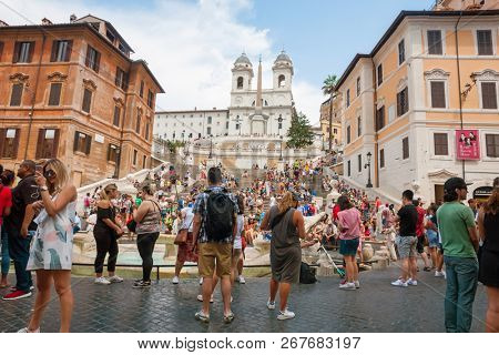 ROME - AUGUST 3: The Spanish Steps, with tourists, seen from Piazza di Spagna on August 3, 2018, Rome.The Spanish Steps are the widest staircase in Europe.