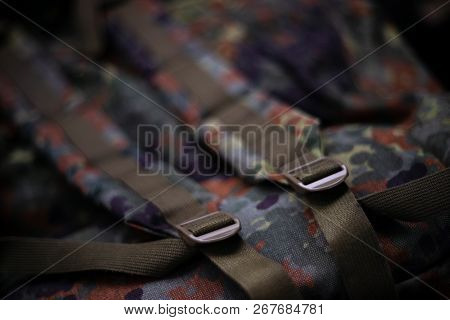 Military Camouflage Roomy Backpack. In The Frame Of The Strap And The Back Of A Backpack. Close-up V