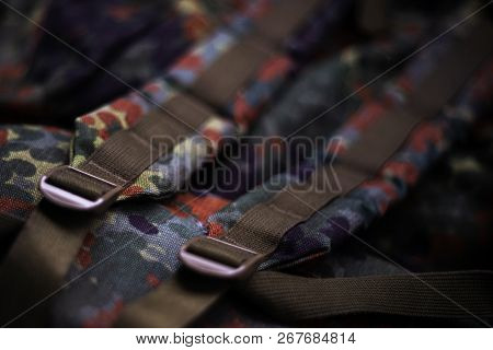 Military Camouflage Roomy Backpack. In The Frame Of The Strap And The Back Of A Backpack. Close-up V