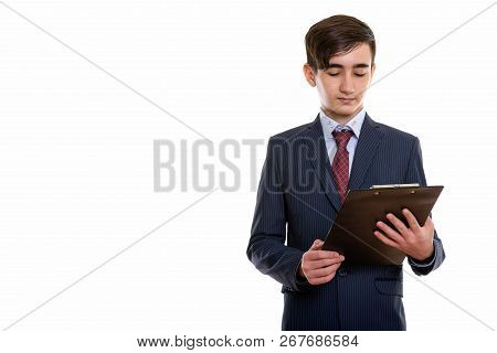Studio Shot Of Young Handsome Persian Teenage Businessman Lookin