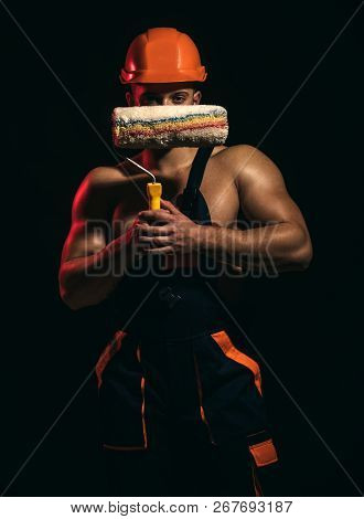 Painting That Youll Be Proud Of. Worker Hold Brush Roller In Muscular Hands. Skilled Painter Or Deco