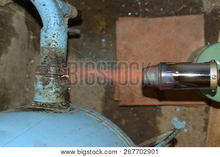Heating A Steel Pipe With A Blowtorch. The Flame Of A Blowtorch.