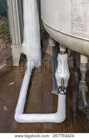 The Side Close Up View Of A Liquid Oxygen Tank With Some Of The Liqud Has Leaked And Solidified Into